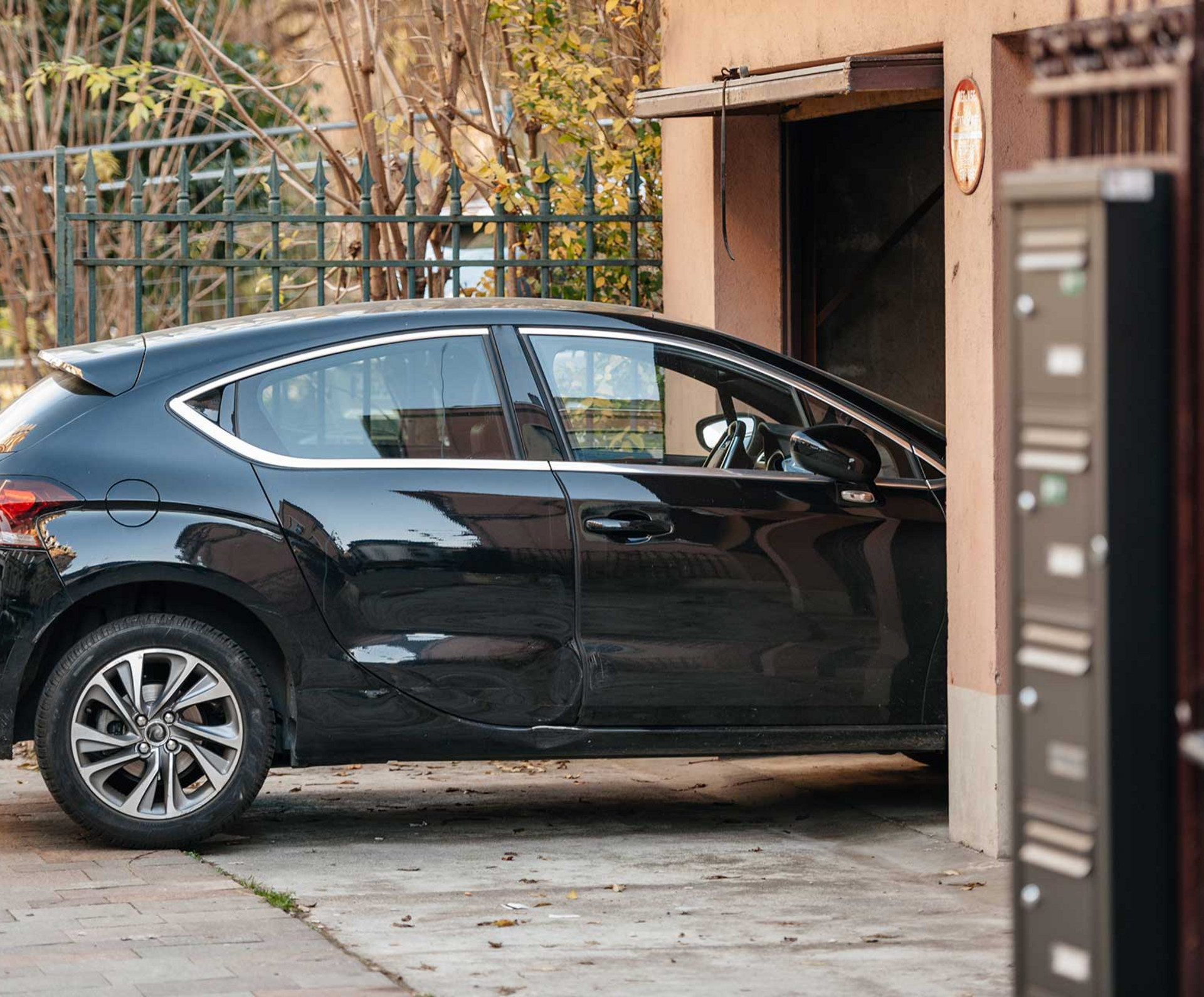 Ein Auto ist vor einer Garage geparkt